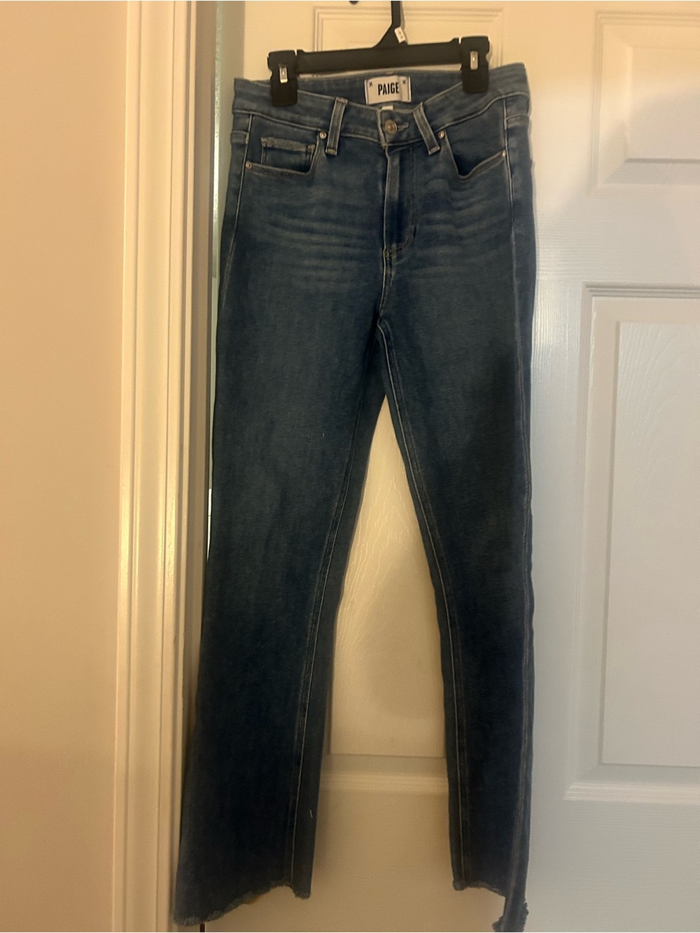 PAIGE high-rise flare jeans featuring a subtle raw hem.